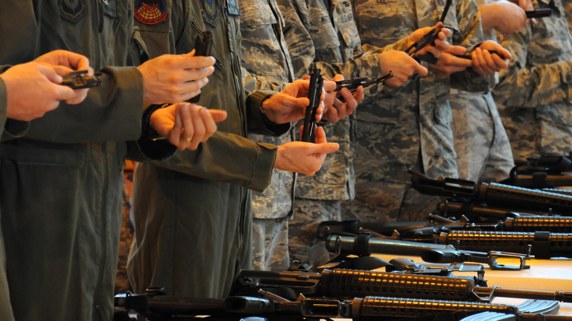 Team Mildenhall members become accustomed to handling a weapon during M16A2 familiarization training July 24, 2014, on RAF Mildenhall, England. Airmen from the 100th Security Forces Squadron taught attendees how to operate a weapon to ensure they are ready to defend the base and its population. (U.S. Air Force photo/Gina Randall/Released)