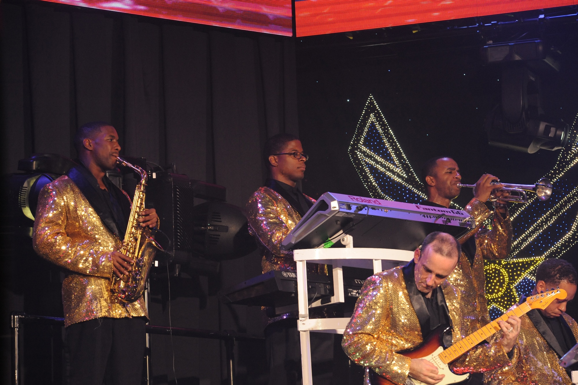 Staff Sgt. Marc Hightower, pictured center, plays his keyboard as a member of the Tops in Blue team, at the Keystone Theater on Kadena Air Base, Japan, July 27, 2014. Hightower is one of Kadena's own, released from the 18th Air Maintenance Squadron in March of 2014. (U.S. Air Force photo by Airman 1st Class Zackary A. Henry/Released)