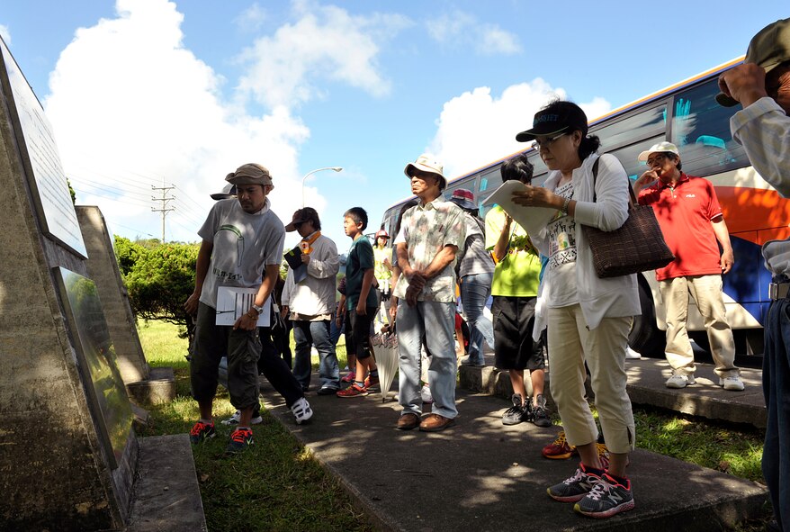An Okinawa City resident takes notes in front of a monument during an annual historical site visit on Kadena Air Base, Japan, July 29, 2014. A historic site is an official location where pieces of political, military or social history have been preserved. Historic sites are usually protected by law, and many have been recognized with the official national historic site status. (U.S. Air Force photo by Naoto Anazawa/Released)