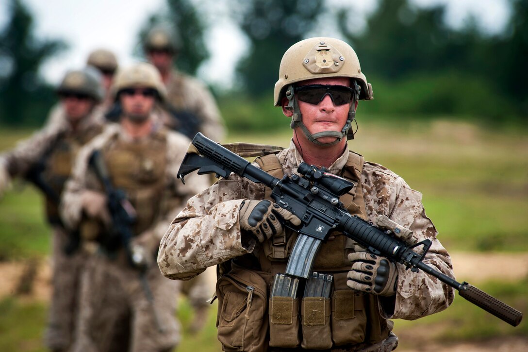 Marine Corps Cpl. Josh Smejkal, foreground, leads a patrol during a live-fire exercise on Camp Upshur on Marine Corps Base Quantico, Va., July 21, 2014. Smejkal is assigned to Echo Company, 4th Reconnaissance Battalion.