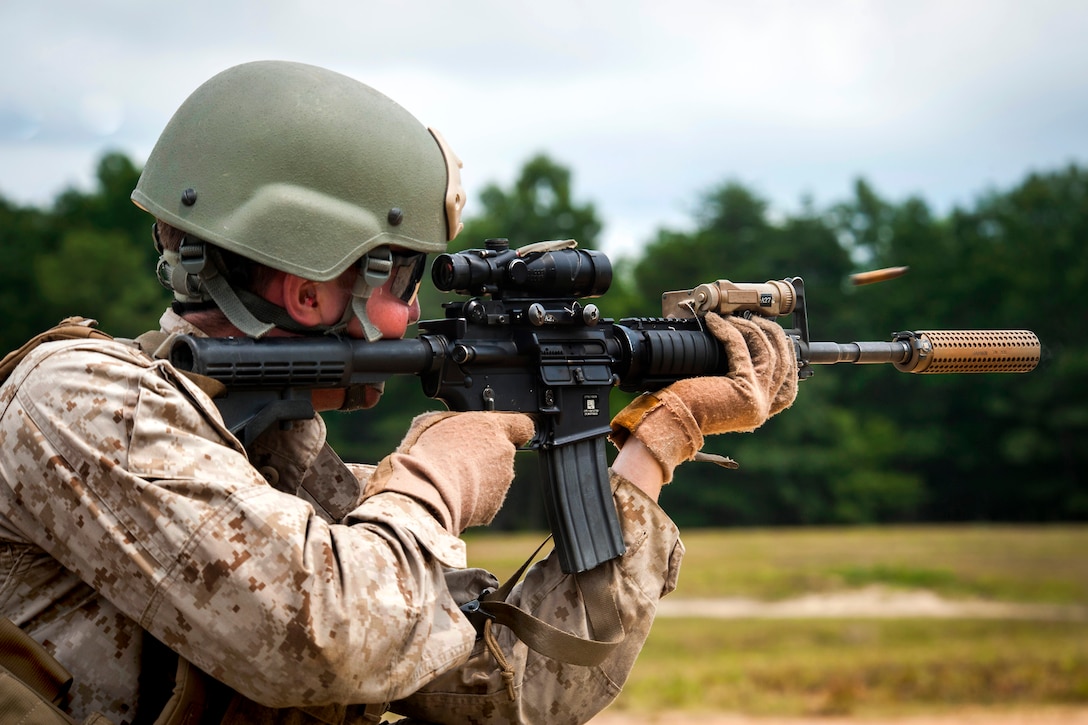 Marine Corps Cpl. Michael Myers responds to a simulated ambush during a ...