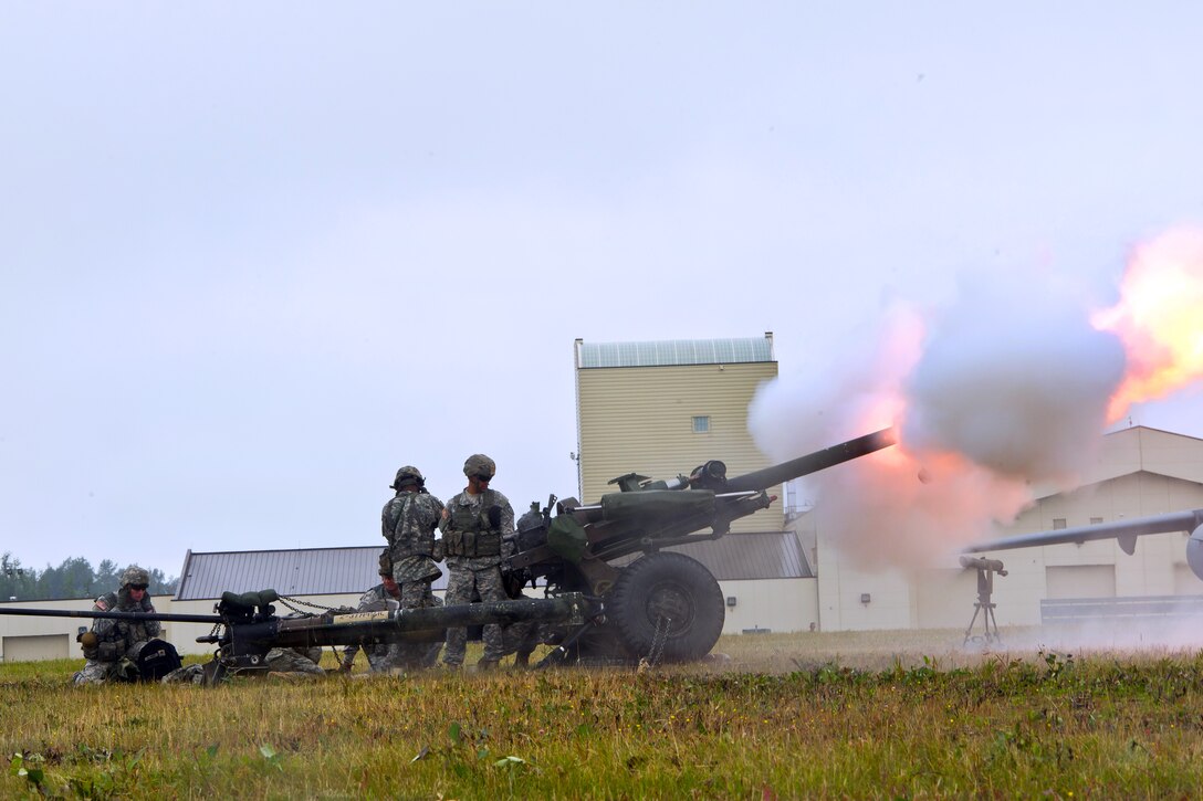 Soldiers fire an M199 105 mm howitzer during a demonstration as part of the Arctic Thunder Open House on Joint Base Elmendorf-Richardson, Alaska, July 25, 2014.