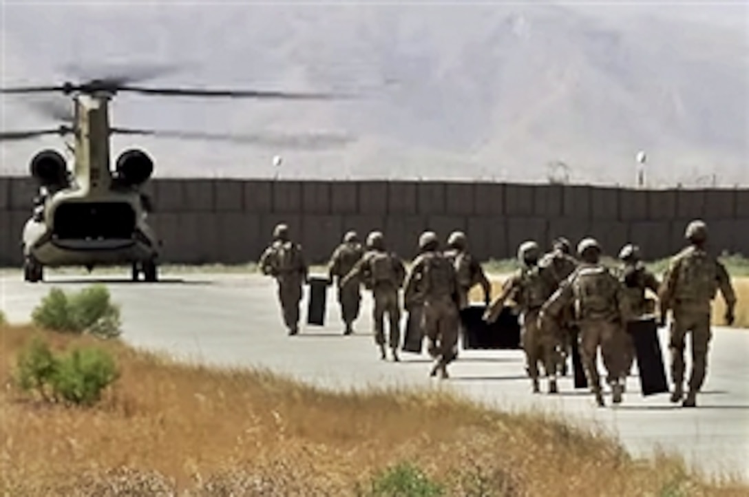 The last U.S. troops on Joint Combat Outpost Khilagay, Afghanistan, turn over the base to the Afghan army and say farewell, July 30, 2014.