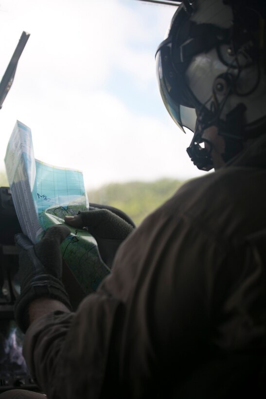Capt. Aaron T. Nelson plans the route to the next coordinates on a map July 16 at Marine Corps Air Station Futenma. Nelson, an Arlington, Texas, native, was flying the CH-53 Super Stallion as part of an air training exercise. Nelson is the officer in charge of the detachment flight line with Marine Heavy Helicopter Squadron 361, Marine Aircraft Group 16, currently attached to Marine Medium Tiltrotor Squadron 265 Reinforced, 31st Marine Expeditionary Unit. (U.S. Marine Corps photo by Lance Cpl. Tyler S. Giguere/Released)