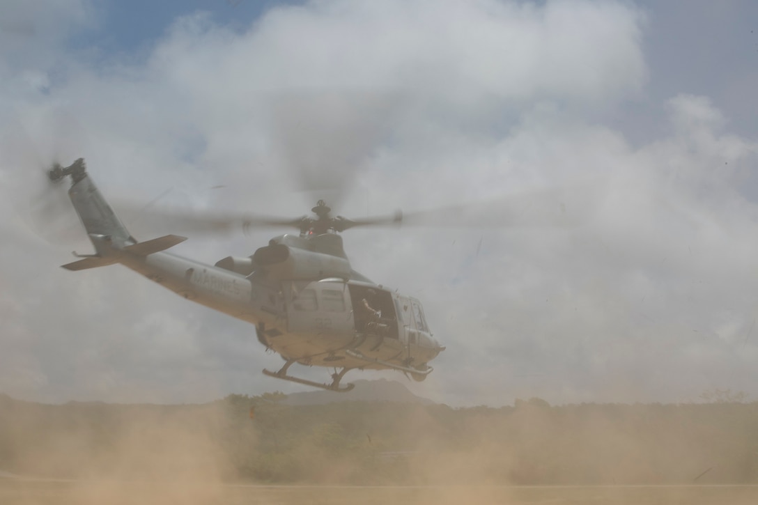 A UH-1 Huey takes off in response to a simulated medical evacuation scenario during an air training exercise July 16 at the Central Training Area. The Huey was used as a medical evacuation response and command post during the exercise. The aircraft is with Marine Light Attack Helicopter Squadron 467, Marine Aircraft Group 29, currently attached to Marine Medium Tiltrotor Squadron 265 Reinforced, 31st Marine Expeditionary Unit. (U.S. Marine Corps photo by Lance Cpl. Tyler S. Giguere/Released)