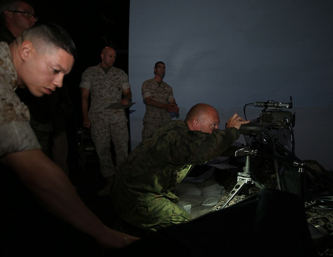 Lt. Col. Artur Romanowski, head of operational planning section, Field Artillery, General Command of the Polish Armed Forces looks through some of the equipment used by a Marine Corps fire support team during a demonstration at the Supporting Arms Virtual Trainer, July 28, 2014.


