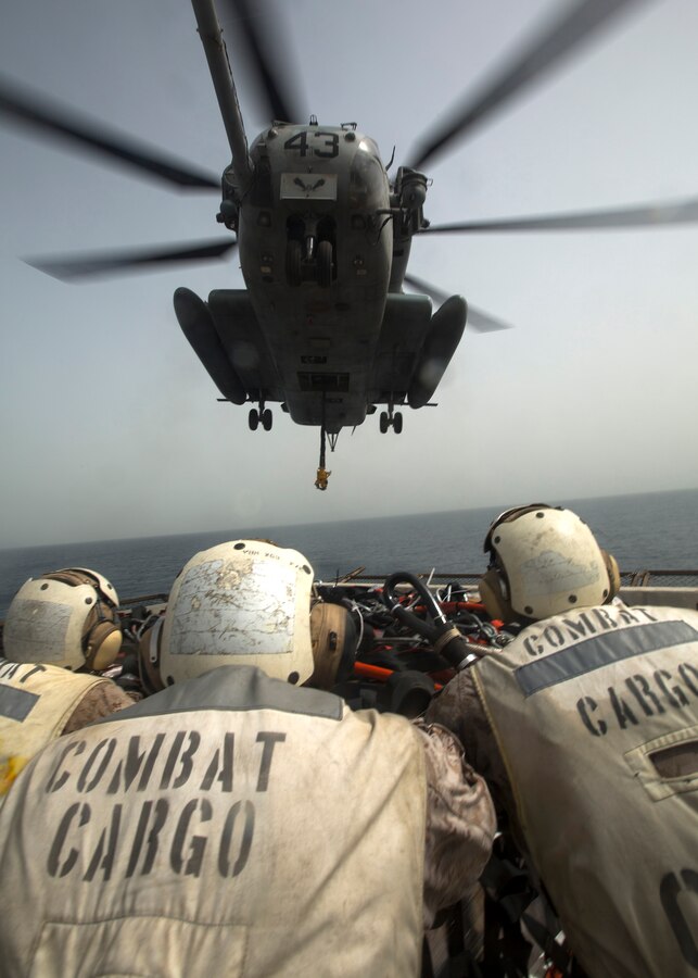 U.S. 5TH FLEET AREA OF RESPONSIBILITY (July 24, 2014) U.S. Marines with landing support platoon, Combat Logistics Battalion 22, 22nd Marine Expeditionary Unit (MEU), prepare to attach a pallet of cargo to a CH-53E Super Stallion with Marine Medium Tiltrotor Squadron (VMM) 263 (Reinforced) during a helicopter support team exercise aboard the amphibious transport dock ship USS Mesa Verde (LPD 19). The 22nd MEU is deployed with the Bataan Amphibious Ready Group as a theater reserve and crisis response force throughout U.S. Central Command and the U.S. 5th Fleet area of responsibility. (U.S. Marine Corps photo by Cpl. Manuel A. Estrada/Released)