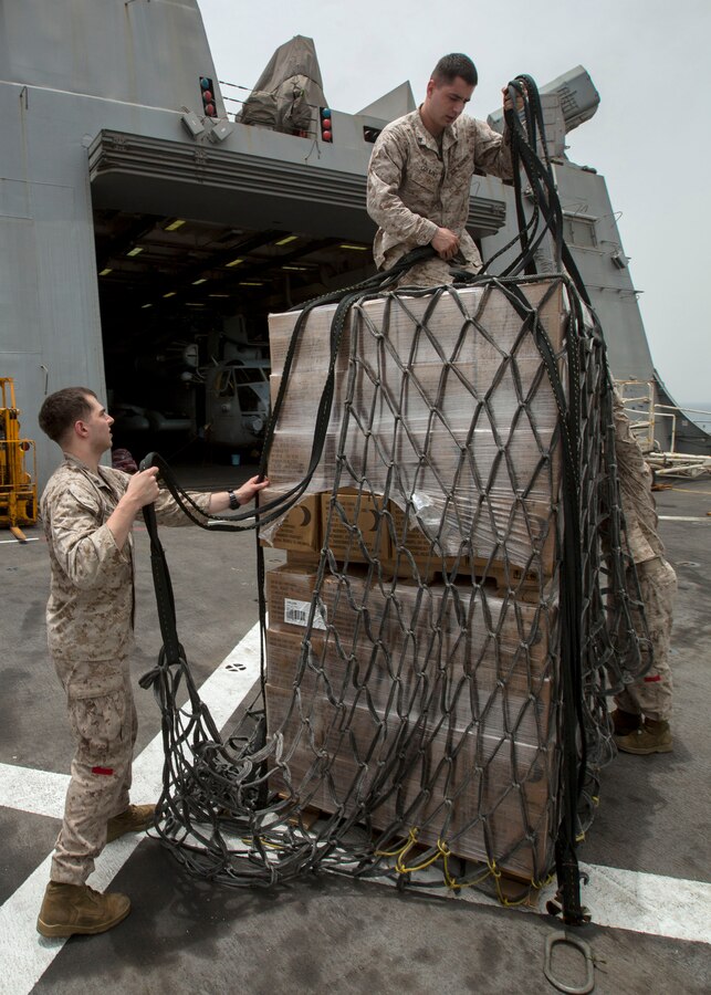 U.S. 5TH FLEET AREA OF RESPONSIBILITY (July 24, 2014) U.S. Marines with landing support platoon, Combat Logistics Battalion 22, 22nd Marine Expeditionary Unit (MEU), prepare a pallet of cargo for transport during a helicopter support team exercise aboard the amphibious transport dock ship USS Mesa Verde (LPD 19). The 22nd MEU is deployed with the Bataan Amphibious Ready Group as a theater reserve and crisis response force throughout U.S. Central Command and the U.S. 5th Fleet area of responsibility. (U.S. Marine Corps photo by Cpl. Manuel A. Estrada/Released)