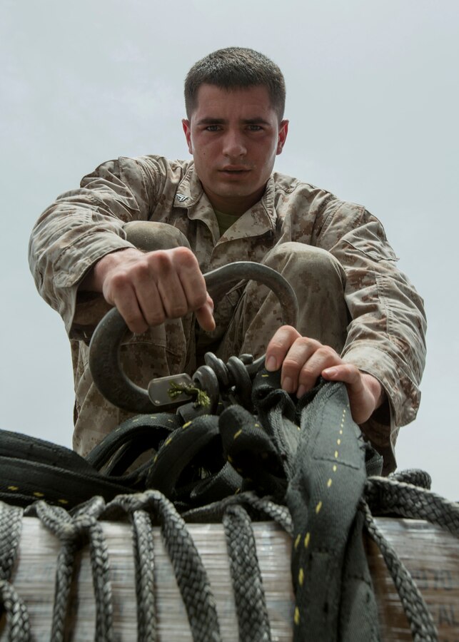 U.S. 5TH FLEET AREA OF RESPONSIBILITY (July 24, 2014) U.S. Marine Corps Cpl. Richard Collins, Combat Logistics Battalion 22, 22nd Marine Expeditionary Unit (MEU), landing support specialist and native of Detroit, prepares a pallet of cargo for transport during a helicopter support team exercise aboard the amphibious transport dock ship USS Mesa Verde (LPD 19). The 22nd MEU is deployed with the Bataan Amphibious Ready Group as a theater reserve and crisis response force throughout U.S. Central Command and the U.S. 5th Fleet area of responsibility. (U.S. Marine Corps photo by Cpl. Manuel A. Estrada/Released)