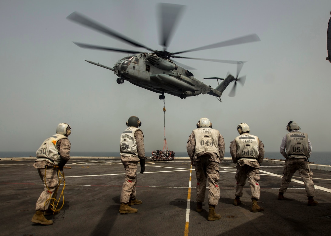 U.S. 5TH FLEET AREA OF RESPONSIBILITY (July 24, 2014) U.S. Marines with landing support platoon, Combat Logistics Battalion 22, 22nd Marine Expeditionary Unit (MEU), brace themselves as a CH-53E Super Stallion with Marine Medium Tiltrotor Squadron (VMM) 263 (Reinforced) lifts off the flight deck with several pallets of cargo during a helicopter support team exercise aboard the amphibious transport dock ship USS Mesa Verde (LPD 19). The 22nd MEU is deployed with the Bataan Amphibious Ready Group as a theater reserve and crisis response force throughout U.S. Central Command and the U.S. 5th Fleet area of responsibility. (U.S. Marine Corps photo by Cpl. Manuel A. Estrada/Released)