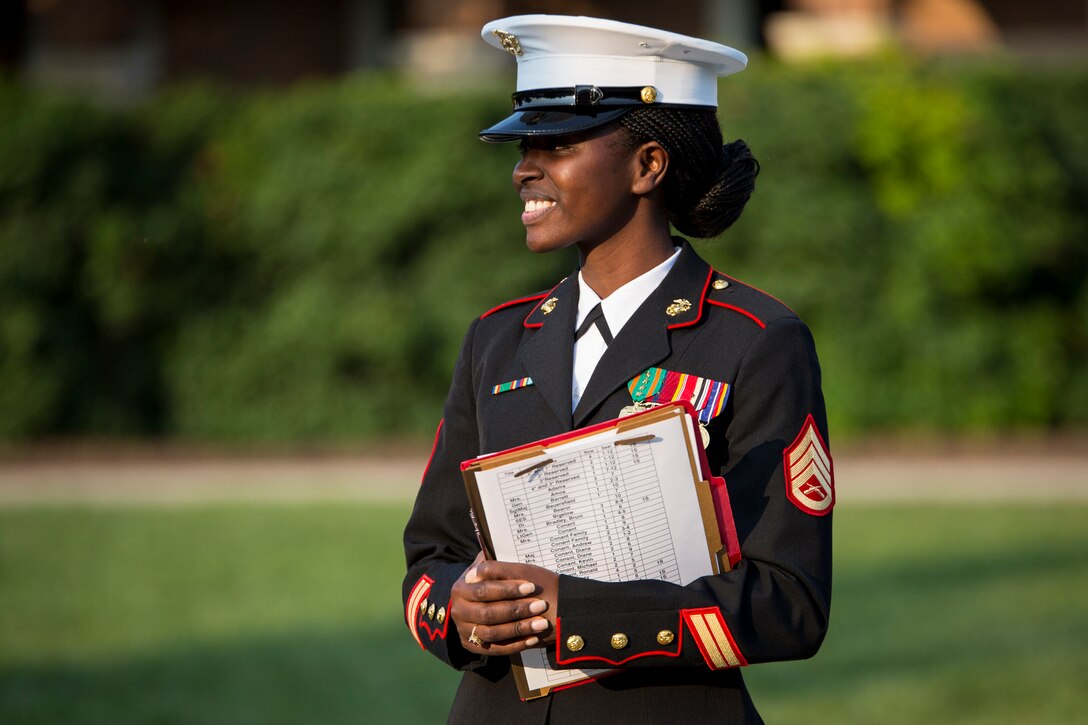 Staff Sgt. Teresia Kamau, protocol chief, greets guests during a retirement ceremony at Marine Barracks Washington, D.C., for Lt. Gen. Thomas Conant, deputy commander of U.S. Pacific Command, July 30.
