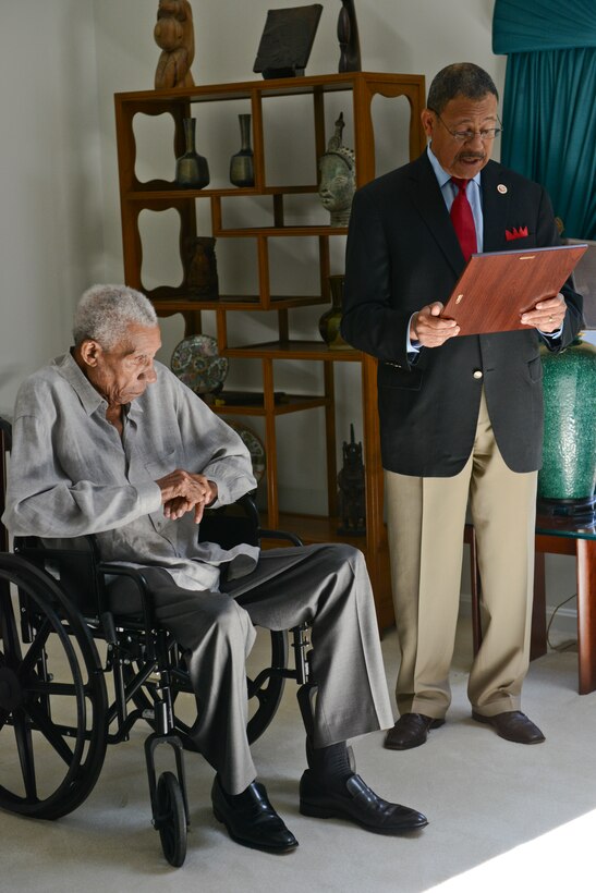 United States Rep. Sanford D. Bishop, Jr., right, reads a Congressional Record statement before presenting it to Lt. Gen. Frank E. Petersen, Jr. (ret.) in honor of his significant accomplishments throughout his military career at his home in Stevensville, Maryland July 28. 