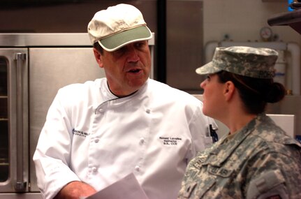 Chef Ronald Lavallee, a culinary instructor at Johnson & Wales University, and Army Sgt. Shannon Roppolo, a food service specialist and shift leader with Company E, 2nd Battalion,135th General Support Aviation, strategize over a recipe at Buckley Air Force Base in Aurora, Colo., Jan. 7. 2012. Lavallee works with the troops during drill on a volunteer basis to teach them advanced culinary techniques.