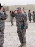 Army Spc. Skeeter Tomczak salutes Army Lt. Col. Eddie Frizell, commander of 1st Squadron, 94th Cavalry, 1st Brigade Combat Team, 34th Infantry Division, after receiving a Purple Heart on Dec. 31, 2011. Tomczak, an Eveleth, Minn., native is a member of Able Troop, 1st Squadron, 94th Cavalry, based out of Hibbing, Minn.