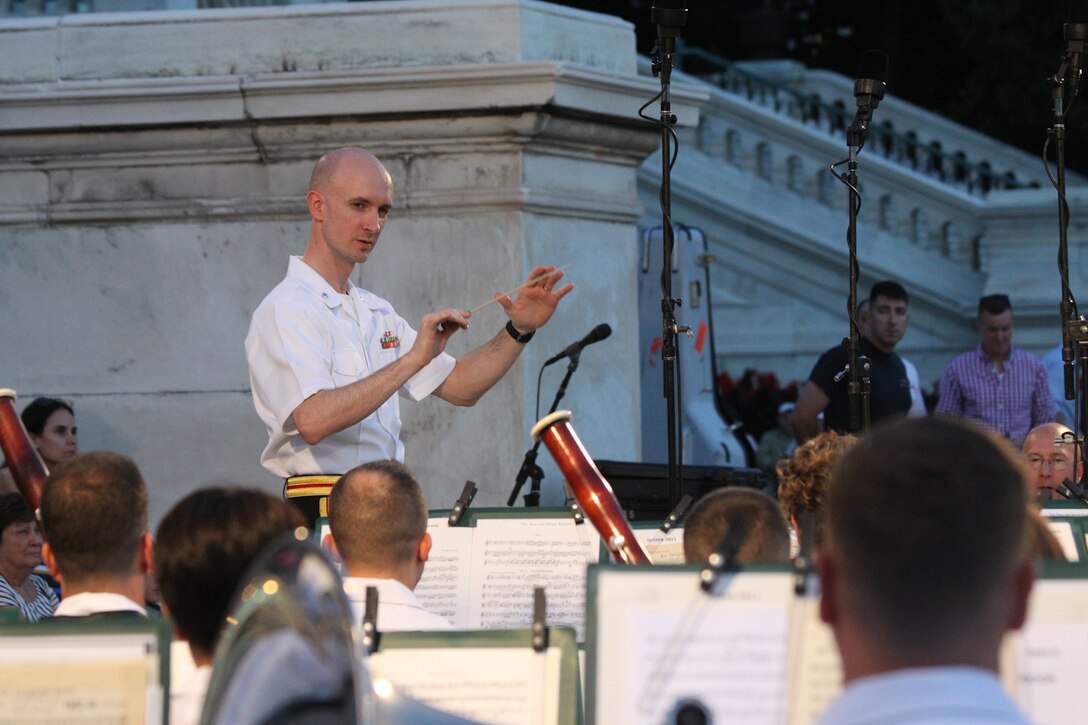On July 30, 2014, Lt. Col. Jason K. Fettig conducted his first Marine Band Summer Fare concert at the U.S. Capitol. The program featured cornet/trumpet player Gunnery Sgt. Brad Weil performing Kenny Baker's "Virtuosity" and mezzo-soprano vocalist Gunnery Sgt. Sara Dell'Omo singing Stephen Sondheim's "You (I) Could Drive a Person Crazy." (U.S. Marine Corps photo by Master Sgt. Kristin duBois/released)