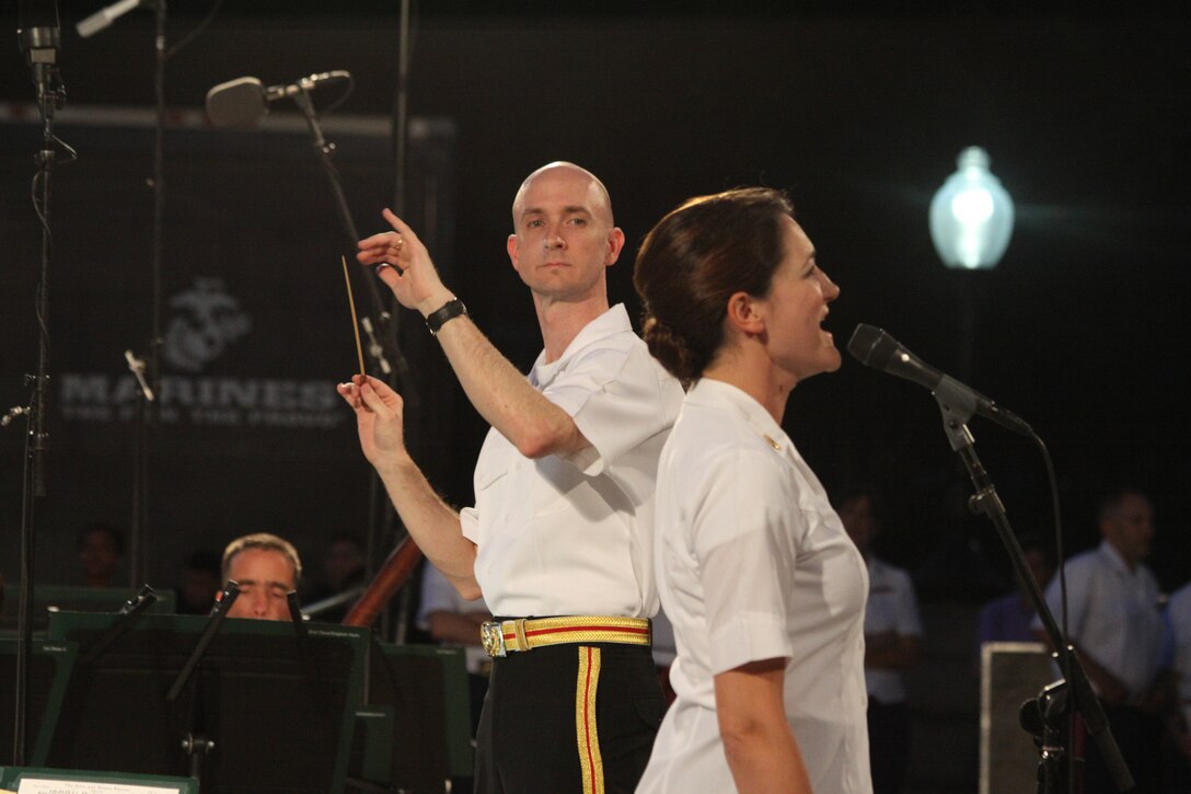 On July 30, 2014, Lt. Col. Jason K. Fettig conducted his first Marine Band Summer Fare concert at the U.S. Capitol. The program featured cornet/trumpet player Gunnery Sgt. Brad Weil performing Kenny Baker's "Virtuosity" and mezzo-soprano vocalist Gunnery Sgt. Sara Dell'Omo singing Stephen Sondheim's "You (I) Could Drive a Person Crazy." (U.S. Marine Corps photo by Master Sgt. Kristin duBois/released)