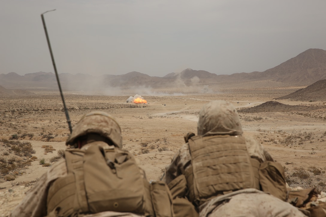 A Fire Support Team with 1st Battalion 1st Marine Regiment, forward observers, observe where joint fires are landing during a Mobile Assault Course in a corridor of the Combat Center training area, July 27, 2014.


