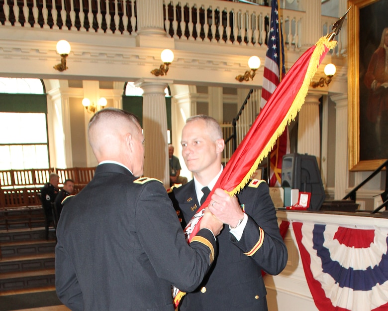 Brig. Gen. Kent D. Savre, Commander of the U.S. Army Corps of Engineers, North Atlantic Division, passes the Corps flag to Col. Christopher Barron in a Change of Command ceremony today at Faneuil Hall in Boston, Mass. Barron is now the district engineer and commander of the New England District of the U.S. Army Corps of Engineers, assuming the command from Col. Charles Samaris. The custom of acknowledging a change in command officers of a military unit is a formal ceremony and dates back to pre-Roman times. The ceremony emphasizes the continuity of leadership and unit identity, despite changes in individual authority, and symbolizes the transfer of command responsibility from one individual to another. This transfer is physically represented by passing the Command Flag, the tangible symbol of the unit, from the outgoing commander to the next senior commander to the new commander.
