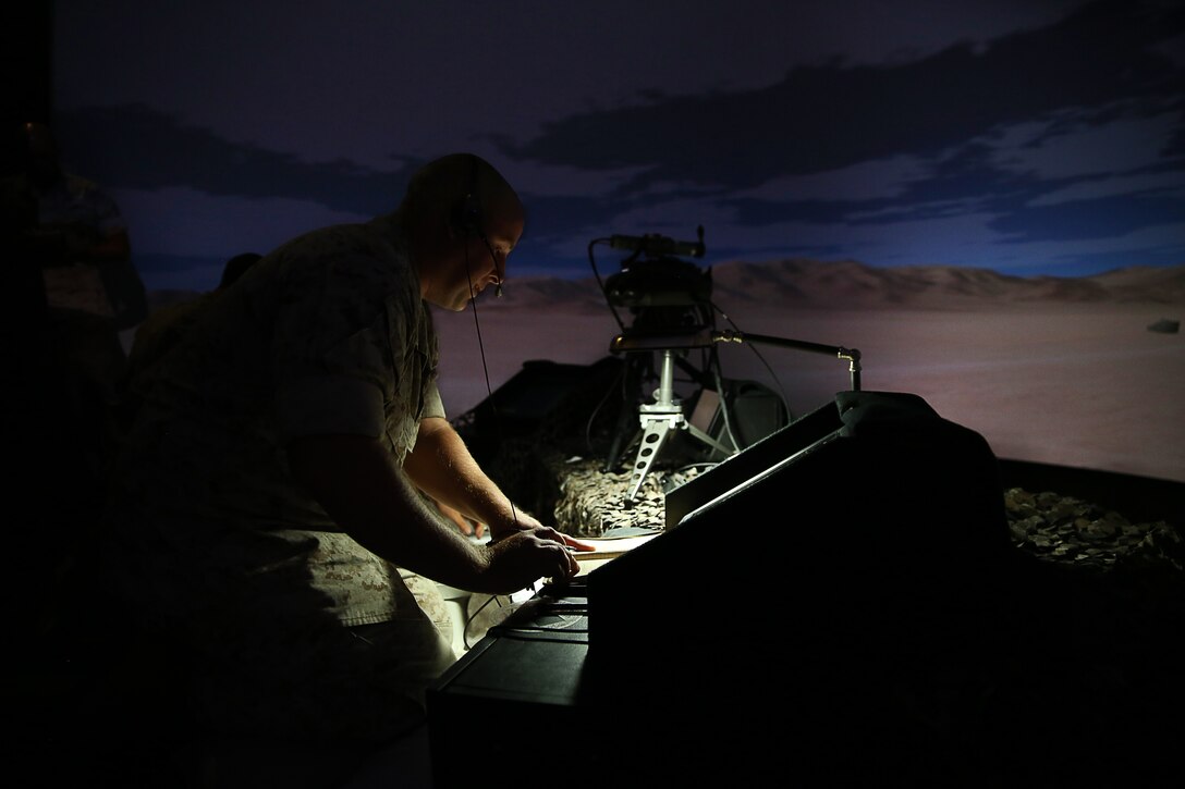 Sgt. Michael A. Kinne, fires faculty advisor, Marine Corps Tactics and Operations Group, calls for suppression on a simulated target during a demonstration at the Supporting Arms Virtual Trainer, July 28, 2014.



