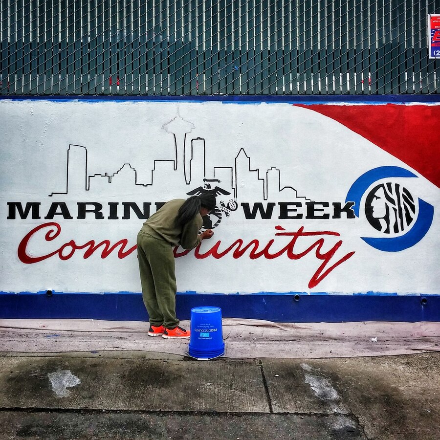 Lance Cpl. Brianua Birl, a production specialist with Marine Corps Recruit Depot San Diego, works to complete her portion of a mural in downtown Seattle, July 24, in preparation for Marine Week Seattle, the #MarineCorps' largest celebration of country, community and Corps, July 26 - Aug. 3. (United States Marine Corps photo by Sgt. Reece Lodder)
 