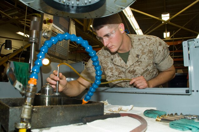 Marine reservist Lance Cpl. Johnathan Ricketts, machinist, Heavy Equipment Platoon, 6th Engineering Support Company, 6th Engineering Support Battalion, Battle Creek, Michigan, measures the diameter of a hole he bored in a wobbler used in the power steering column of an assault amphibious vehicle, Friday, during his annual training at Marine Corps Logistics Base Albany, Georgia.