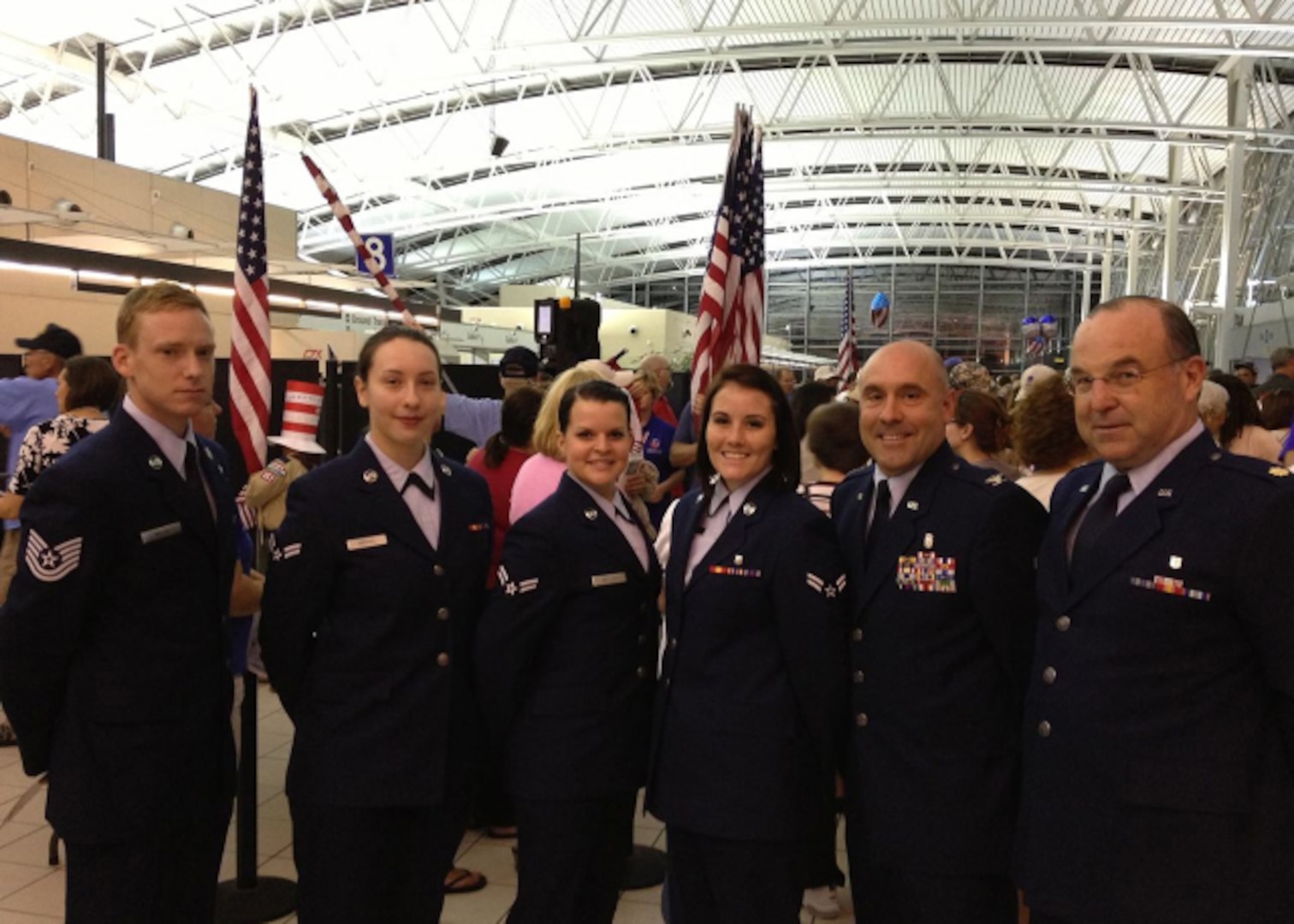Members from the Illinois Air National Guard's 126th Air Refueling Wing stand at Lambert International Airport, St. Louis, July 8, 2014, after greeting veterans during the Greater St. Louis Area Honor Flight. 