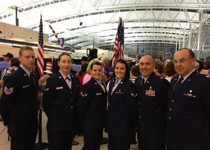 Members from the Illinois Air National Guard's 126th Air Refueling Wing stand at Lambert International Airport, St. Louis, July 8, 2014, after greeting veterans during the Greater St. Louis Area Honor Flight. 