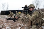 Soldiers with Headquarters Company 1st Battalion, 143rd Infantry (Airborne) of the Texas Army National Guard prepare to assault a suspected improvised explosive device lab encountered while on a foot patrol during training at Camp Atterbury Joiunt Maneuver Training Center, Ind., Jan. 14, 2012. The Texas National Guard battalion has been tasked with providing security for the next rotation of Provincial reconstruction Teams bound for Afghanistan this spring.