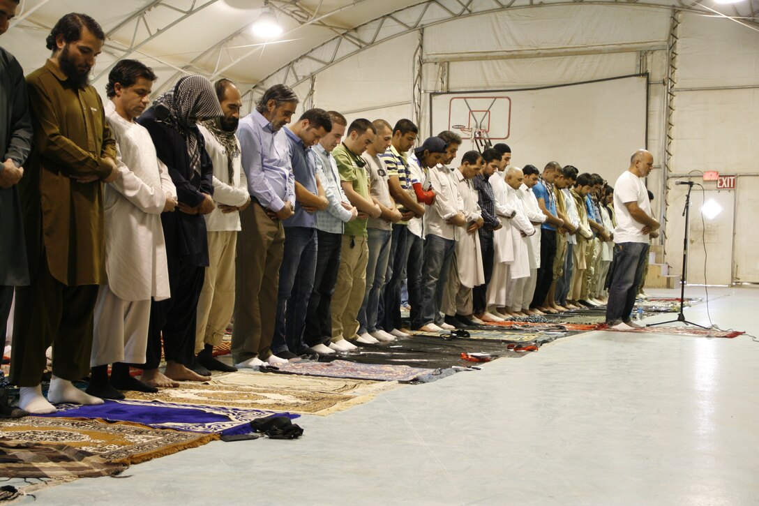 Coalition service members and civilian contractors participate in an Eid al-Fitr ceremony held aboard Camp Leatherneck, Helmand province, Afghanistan, July 28, 2014. The ceremony marked the end of Ramadan, which is a monthlong holiday that millions of Muslims observe each year by fasting from morning to evening.

