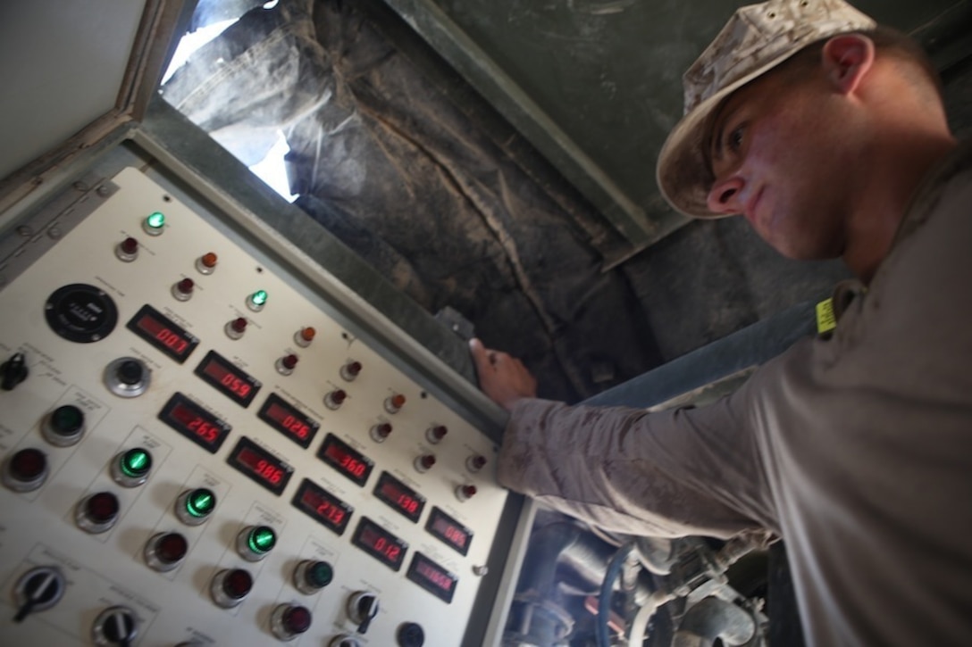 Corporal Marc-Anthony Diplacido, a water support technician with Combat Logistics Battalion 7, monitors a water pump system during a daily inspection aboard Camp Dwyer, Helmand province, Afghanistan, July 21, 2014. Water support technician Marines produce approximately 50,000 gallons of water each day to support coalition forces stationed aboard Camp Dwyer. (U.S. Marine Corps photo by Cpl. Cody Haas/ Released)