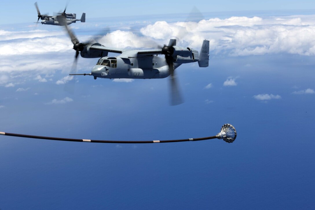 An MV-22B Osprey, with Marine Medium Tiltrotor Squadron 163, 11th Marine Expeditionary Unit, maneuvers into position to receive fuel en route to Hawaii, July 30th, 2014. Four Ospreys launched from the USS Makin Island and traveled more than 800 nautical miles to insert an element of Marines into a simulated Embassy compound. The MEU departed San Diego on July 25 and is currently deployed as part of WESTPAC 14-2. (U.S. Marine Corps photo by Lance Cpl. Evan R. White/Released)