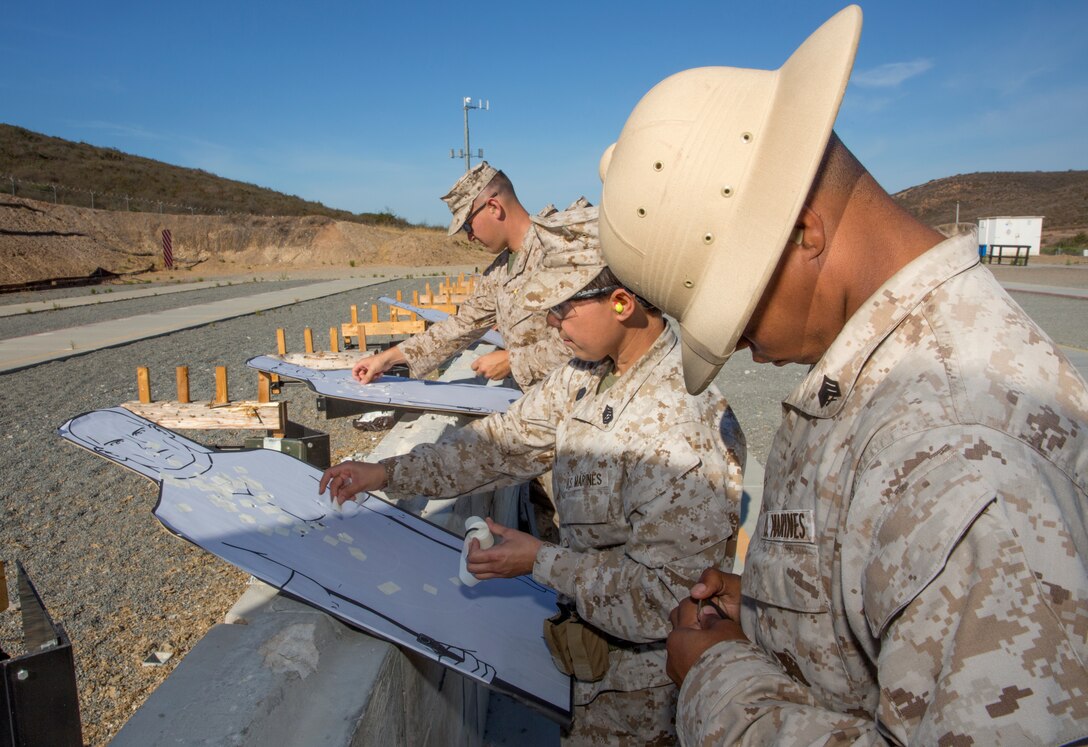 Sgt. Cameron Garrett, right, pistol range noncommissioned officer in charge with Carlos Hathcock Range Complex, fills a pistol magazine after a course of fire for the next course of fire at the range aboard Marine Corps Air Station Miramar, Calif., July 29. The Corps’ newest pistol marksmanship qualification, the Combat Pistol Program, was implemented October 2013 and allows marksmanship coaches Corpswide to make training more realistic for the thousands of Marines and Sailors who train at the range annually.