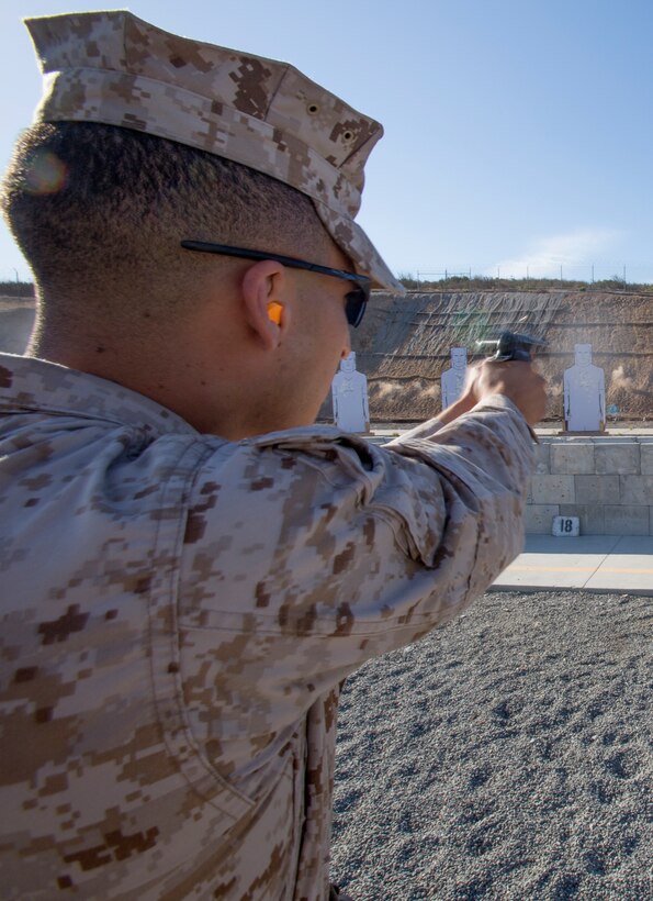 Sgt. Adrian Quinones, an aviation ordnance technician with Marine Medium Tiltrotor Squadron (VMM) 363, fires an M9 Berretta pistol at a human-shaped silhouette at the 7-yard firing line at Carlos Hathcock Range Complex aboard Marine Corps Air Station Miramar, Calif., July 29. Marines are now required to qualify using the Corps’ newest pistol program, called Combat Pistol Program, which changed pistol marksmanship from a competition-style qualification to a combat-minded one.