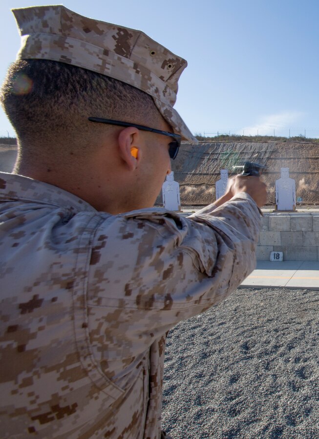 Sgt. Adrian Quinones, an aviation ordnance technician with Marine Medium Tiltrotor Squadron (VMM) 363, fires an M9 Berretta pistol at a human-shaped silhouette at the 7-yard firing line at Carlos Hathcock Range Complex aboard Marine Corps Air Station Miramar, Calif., July 29. Marines are now required to qualify using the Corps’ newest pistol program, called Combat Pistol Program, which changed pistol marksmanship from a competition-style qualification to a combat-minded one.