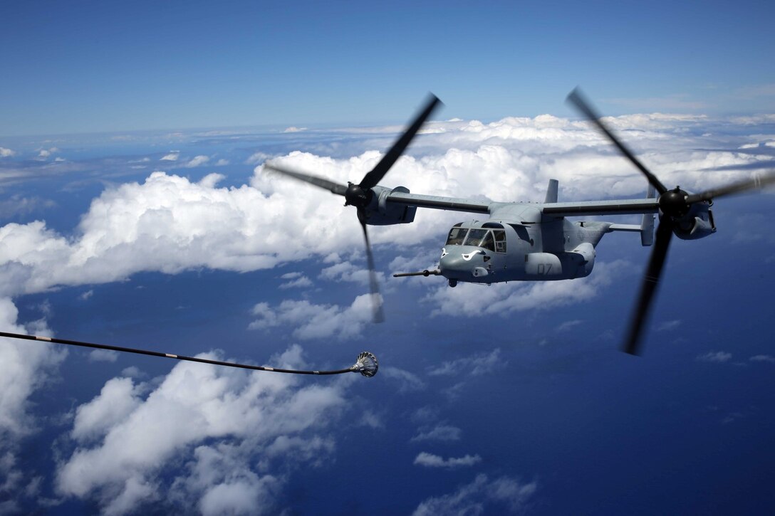 An MV-22B Osprey, with Marine Medium Tiltrotor Squadron 163, 11th Marine Expeditionary Unit, maneuvers into position to receive fuel en route to Hawaii, July 30th, 2014. Four Ospreys launched from the USS Makin Island and traveled more than 800 nautical miles to insert an element of Marines into a simulated embassy compound. The MEU departed San Diego on July 25 and is currently deployed as part of Western Pacific 14-2. (U.S. Marine Corps photo by Lance Cpl. Evan R. White/Released)