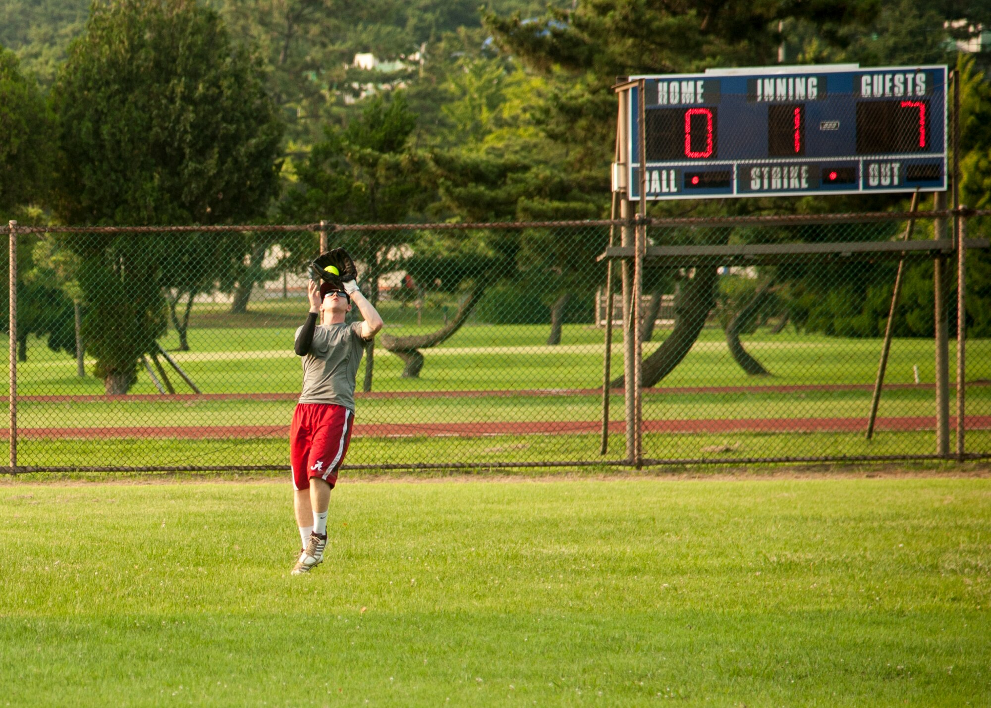 The 8th Maintenance Squadron Dragons play the 8th Civil Engineer Squadron Red Devils during the squadron championship softball game at Kunsan Air Base, Republic of Korea, July 30, 2014. The game’s final score ended with the Dragons taking the win, 14 to 9. (U.S. Air Force photo by Staff Sgt. Jose Rodriguez/Released)