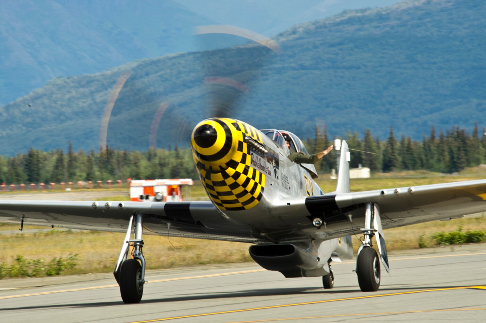 A North American P-51 Mustang  taxis down the runway after performing aerial maneuvers during Arctic Thunder Open House July 27, 2014, Arctic Thunder Open House is a biennial event hosted by Joint Base Elmendorf-Richardson, Alaska. Featuring more than 40 Air Force, Army and civilian aerial acts and an expected crowd of more than 200,000 people, it is the largest two-day event in the state and one of the premier aerial demonstrations in the world. The 2014 Arctic Thunder Open House is a proud part of the Anchorage Centennial Celebration (U.S. Air Force photo by TSgt. Efren Lopez/Released