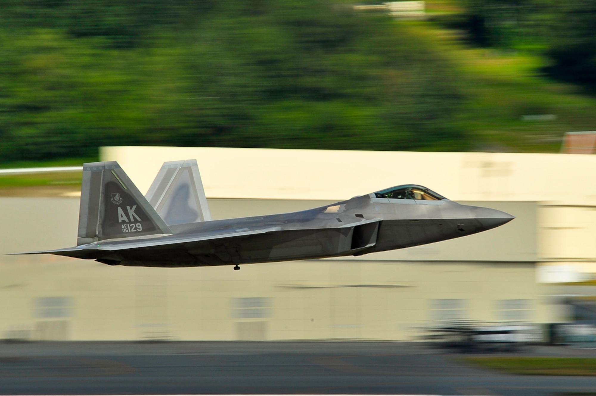 A U.S. Air Force F-22 Raptor fighter jet from the 90th Fighter Squadron, 3rd Operations Group, 3rd Wing performs a low flyby aerial maneuver during the Arctic Thunder Open House July 26, 2014, Arctic Thunder Open House is a biennial event hosted by Joint Base Elmendorf-Richardson, Alaska. Featuring more than 40 Air Force, Army and civilian aerial acts and an expected crowd of more than 200,000 people, it is the largest two-day event in the state and one of the premier aerial demonstrations in the world. The 2014 Arctic Thunder Open House is a proud part of the Anchorage Centennial Celebration (U.S. Air Force photo by TSgt. Efren Lopez/Released)
