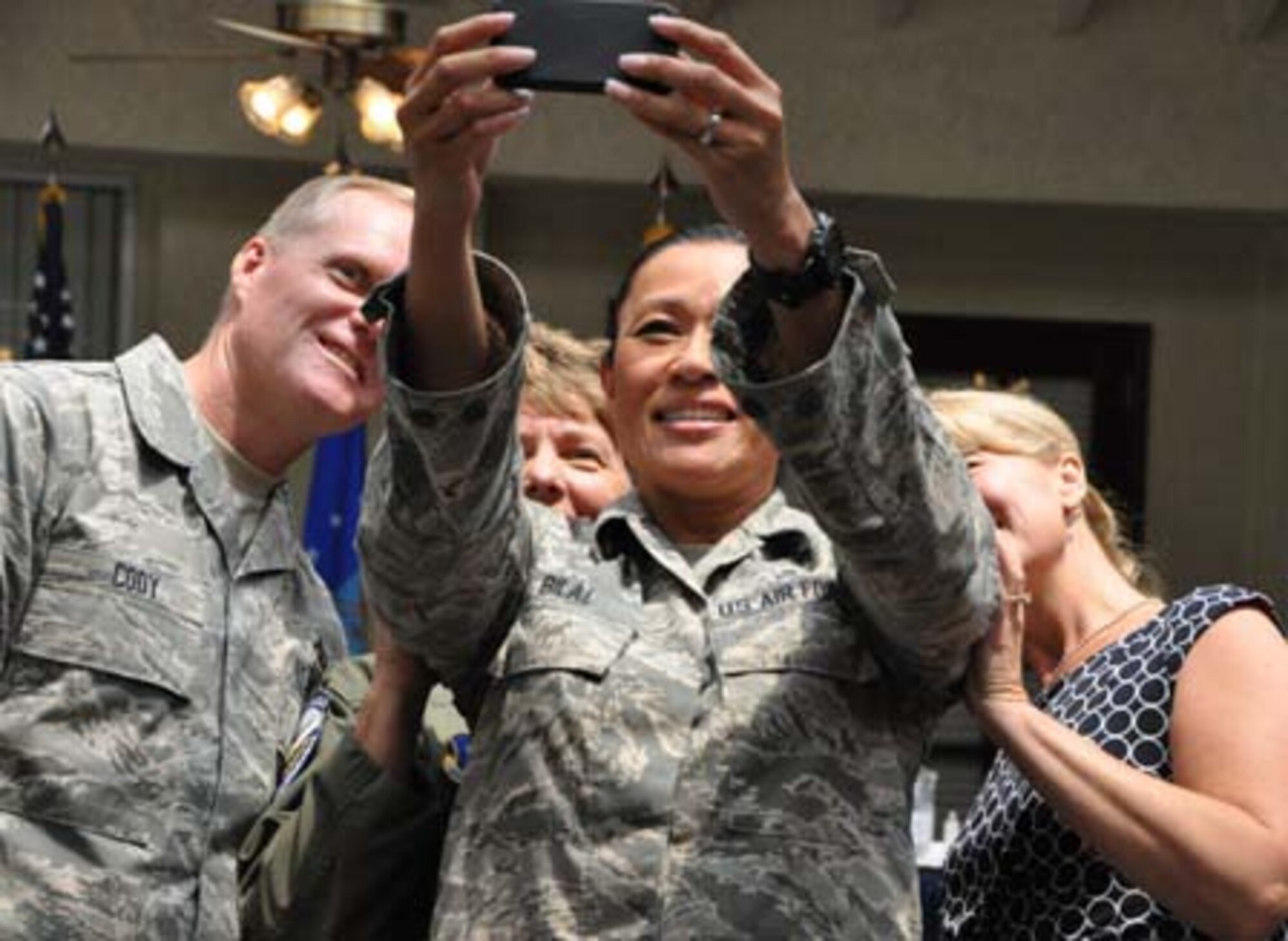 Chief Master Sgt. Timi Bilal, 452nd Aerospace Medical Squadron, takes a ‘selfie’ with (from left) CMSAF James Cody, Chief Master Sgt. Deborah McGuane, 336th Air Refueling Squadron, and Athena Cody. CMSAF Cody and Athena visited March Air Reserve Base in Southern California July 11-14, 2014, where they met with Airmen and observed the success of Total Force Integration there. (U.S. Air Force photo/Master Sgt. Linda Welz)
