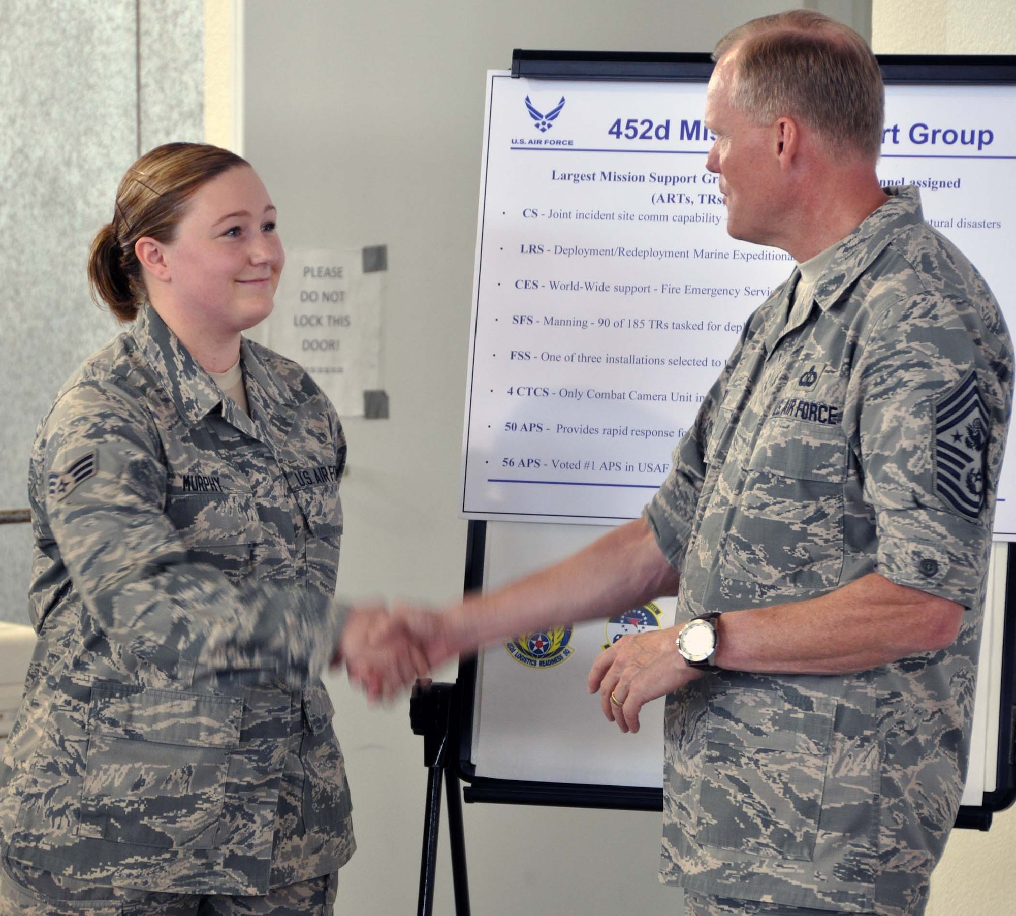 Chief Master Sgt of the Air Force James A. Cody presented his coin to Senior Airman Aubrey Murphy, 56th Aerial Port Squadron, to thank her for doing so well in her explanation of the Mission Support Group’s overall mission. CMSAF Cody and Athena visited March Air Reserve Base in Southern California July 11-14, 2014, where they met with Airmen and observed the success of Total Force Integration there. (U.S. Air Force photo/Master Sgt. Linda Welz)