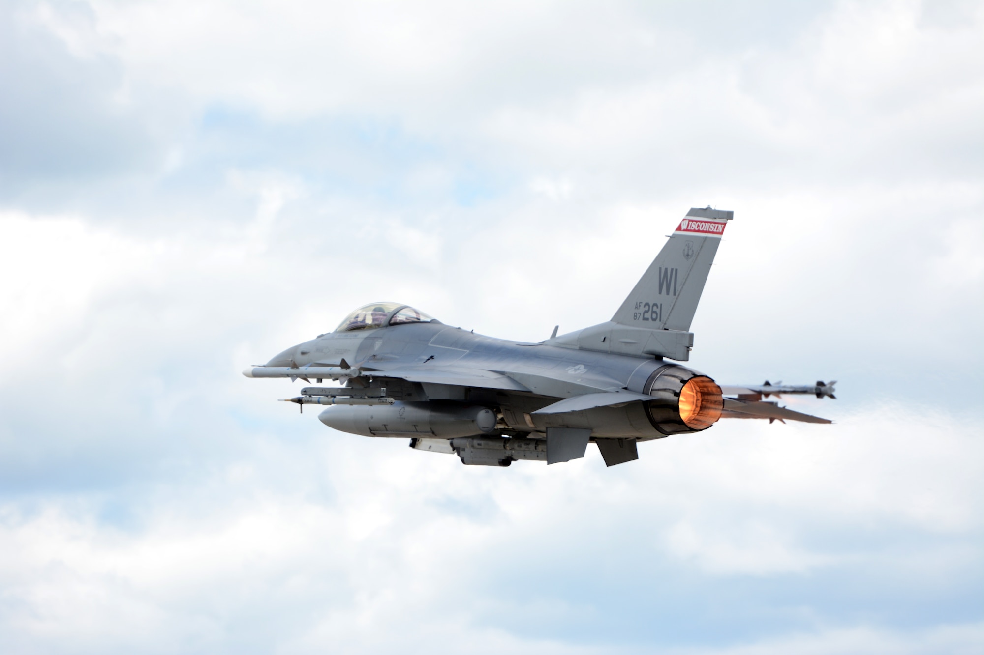 An F-16 Fighting Falcon from the 115th Fighter Wing in Madison, Wis., takes off above Volk Field Air National Guard Base, Wis., July 16, 2014. The jets were moved to Volk Field for the month of July, while the Dane County Regional Airport completed runway maintenance and repairs. (Air National Guard photo by Senior Airman Andrea F. Liechti)