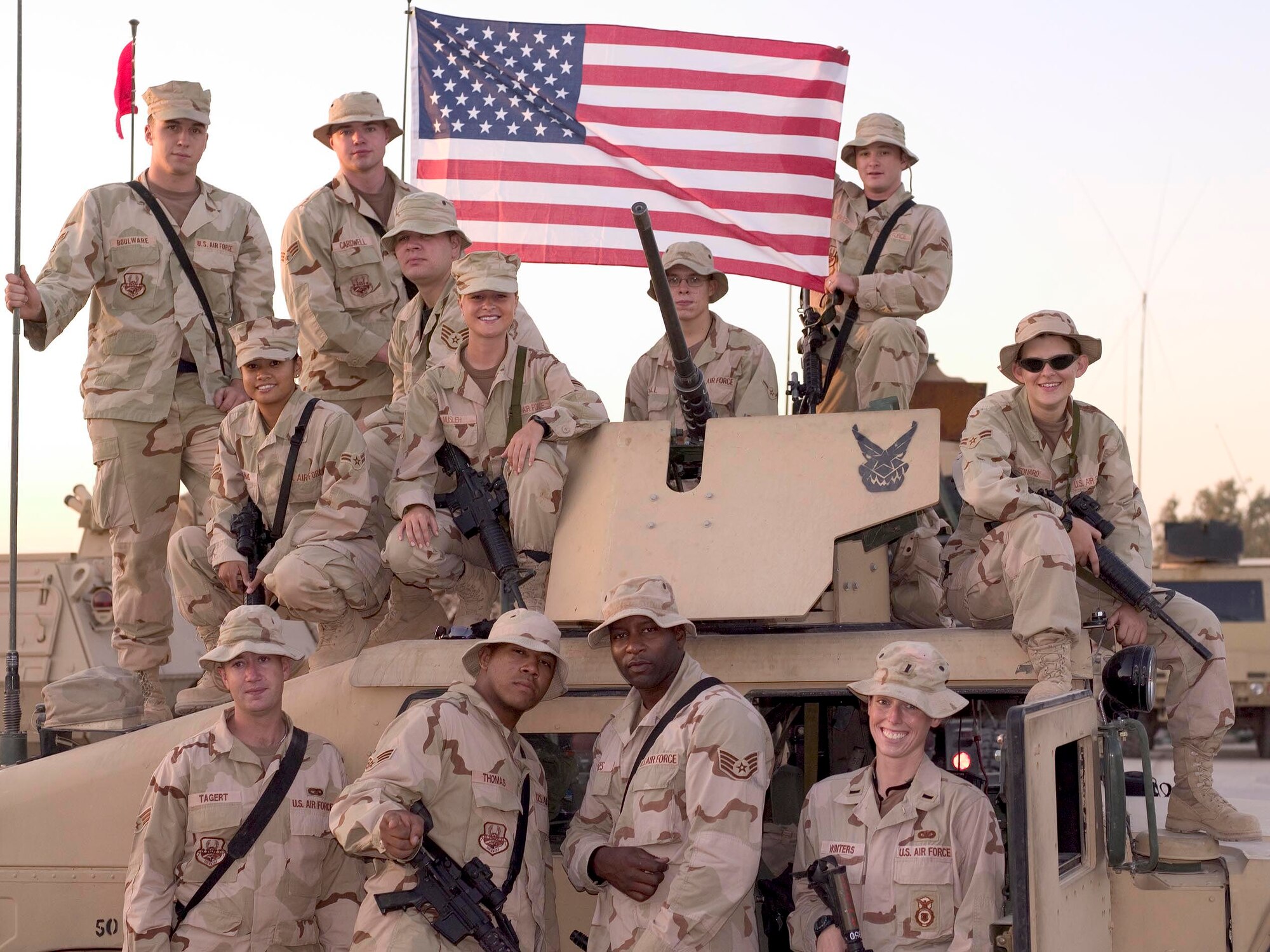 U.S. Airmen assigned to gun truck company Detachment 2632, Alpha Flight, poses for a group photo during a deployment in 2005, Balad Air Base, Iraq. Alpha Flight provided armed escorts for cargo haulers. (courtesy photo)  