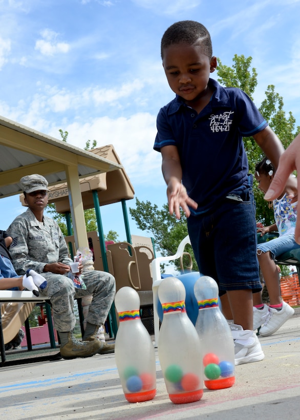 Christopher McElveen, son of Tech. Sgt.’s Christopher McElveen, 28th Maintenance Squadron aircraft fuel systems technician, and Anique McElveen, 28th Maintenance Group unit training manager, participate in the Child Development Center’s Summer Carnival at Ellsworth Air Force Base, S.D., July 24, 2014. CDC staff, along with Airmen and families, set up the carnival to provide activities and games for CDC children to enjoy. (U.S. Air Force photo by Senior Airman Anania Tekurio/Released)