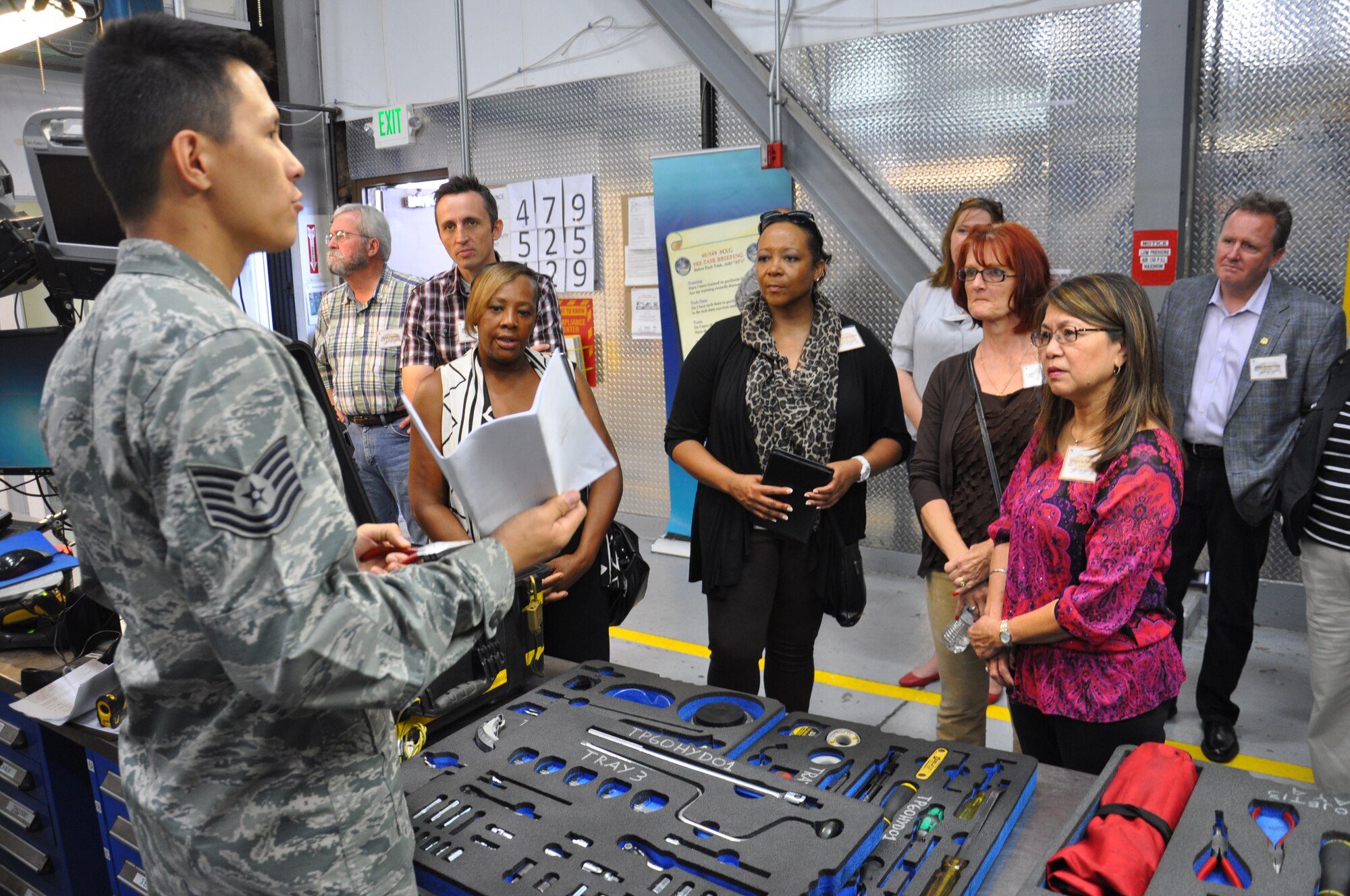 Tech. Sgt. Stephen Mendoza, 60th Aircraft Maintenance Squadron NCO in charge consolidated tool kit, goes over the tool check-in, check-out process with honorary commanders during their tour of the 60th Maintenance Group July 25 at Travis Air Force Base. The honorary commander program is designed to integrate civic leaders from the local community into the military for a two-year term. (U.S. Air Force photo/Senior Airman Bryan Swink)