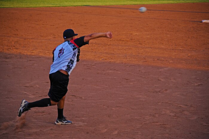 Senior Airmen Richard Rivera, Beale All-Stars third baseman, throws the ball to first base during a softball game the Marysville Gold Sox July 30, 2014, at Appeal-Democrat Park in Marysville, Calif. The Beale All-Stars came out victorious in a 7-4 win. (U.S. Air Force photo by Airman 1st Class Ramon A. Adelan/ Released)