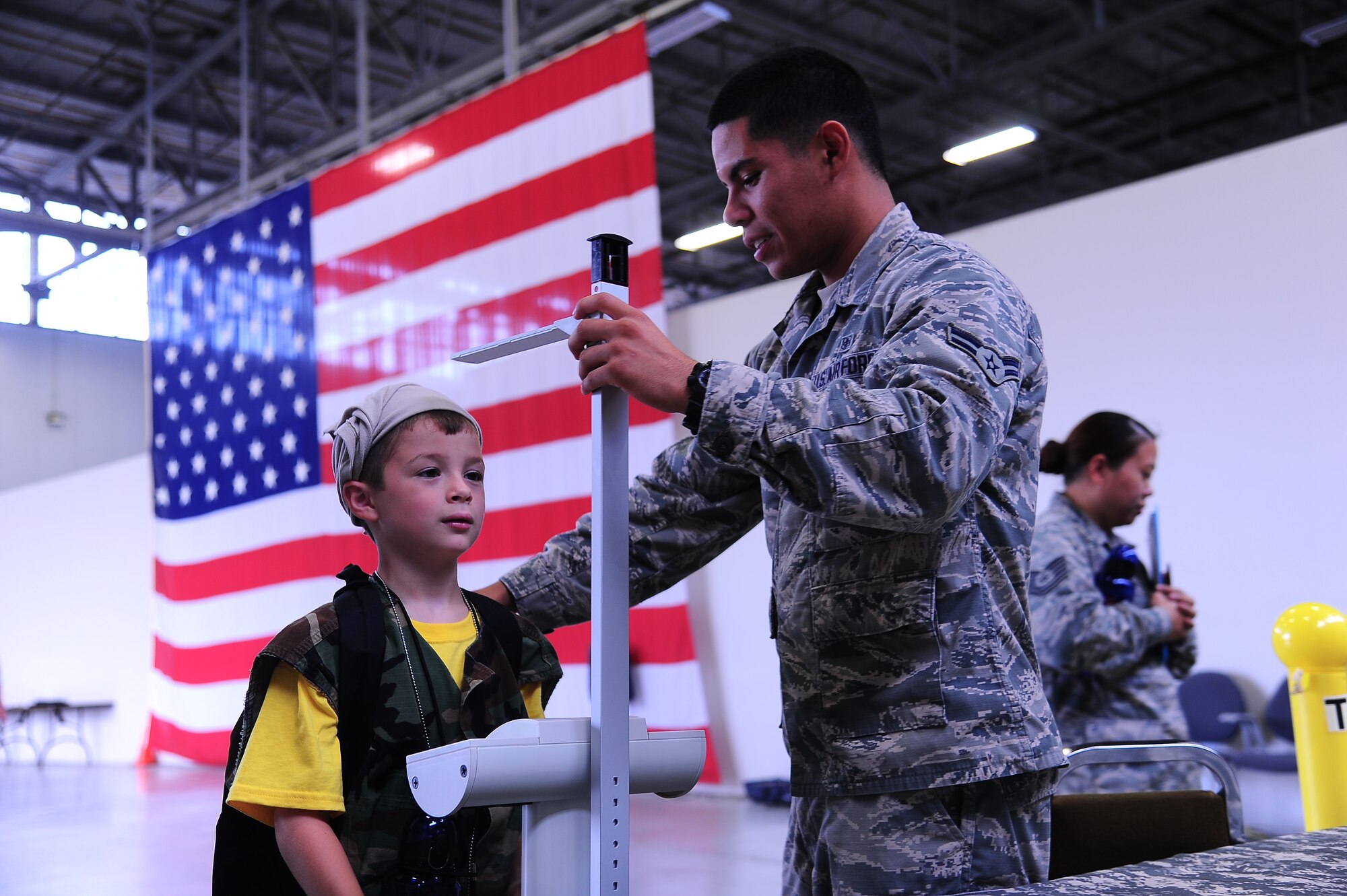 Airman 1st Class Dimitri Munoz, 14th Medical Operations Squadron, measures
the height of Charles Woford, son of Staff Sgt. Charles Woford, 14th Flying
Training Wing Chapel, as he progresses through his mock deployment
processing July 31 during the Youth Deployment Camp at the Walker Center.
During the camp children experienced getting simulated immunization shots,
getting their height and weight taken, military working dog demonstrations
and smoke house evacuation procedures, all of which mirror what their
parents or guardians go through while preparing for deployment. (U.S. Air
Force photo/Airman 1st Class Daniel Lile)
