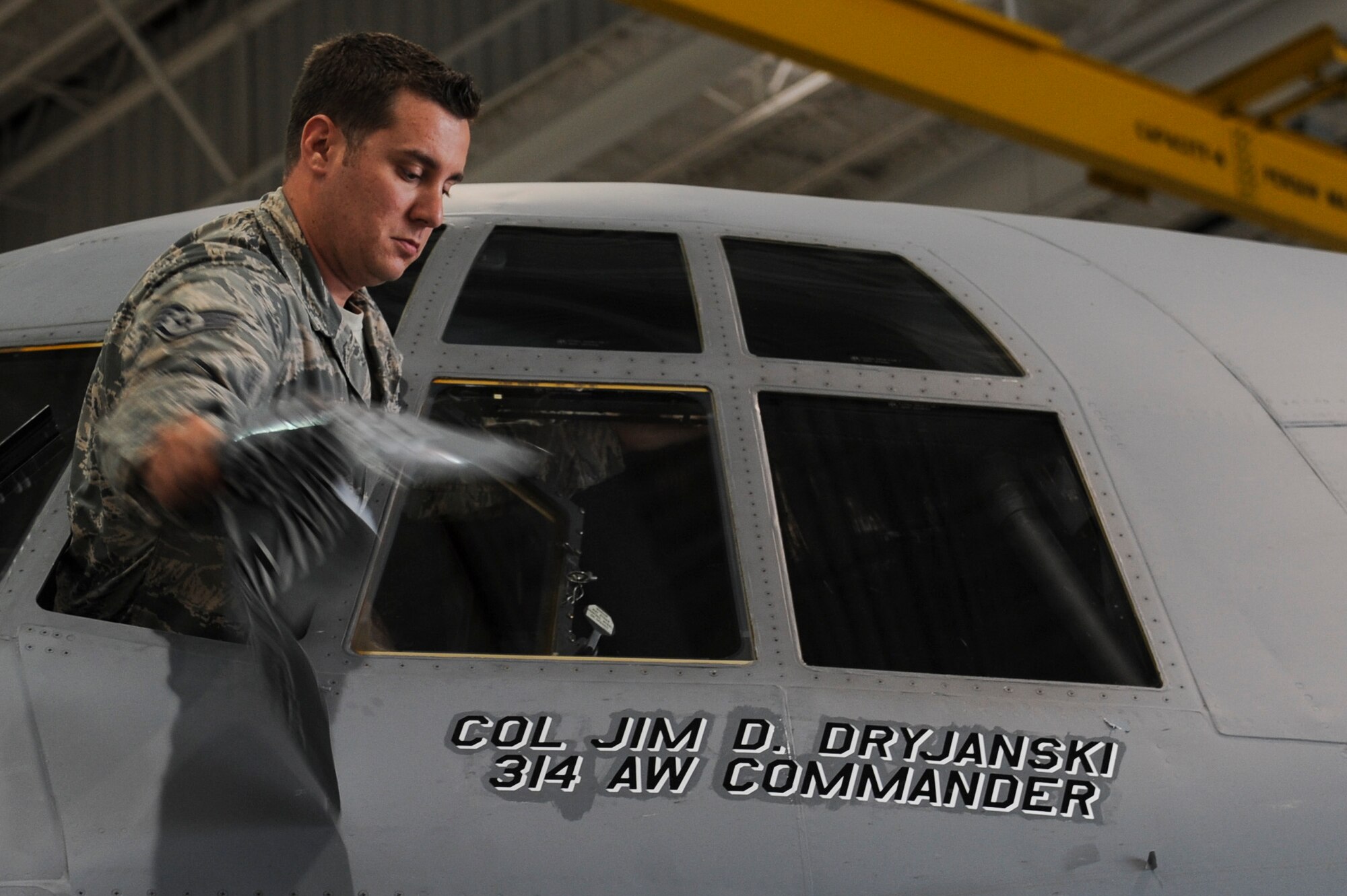 Staff Sgt. Michael Griffin, a 314th Aircraft Maintenance Squadron dedicated crew chief, unveils the name of Col. James Dryjanski, 314th Airlift Wing commander, on the wing’s flagship July, 31, 2014, at Little Rock Air Force Base, Ark. Dryjanski  leads a team of approximately 1,200 military and civilian professionals who form the C-130 Center of Excellence for tactical airlift. (U.S. Air Force photo by Airman 1st Class Cliffton Dolezal)