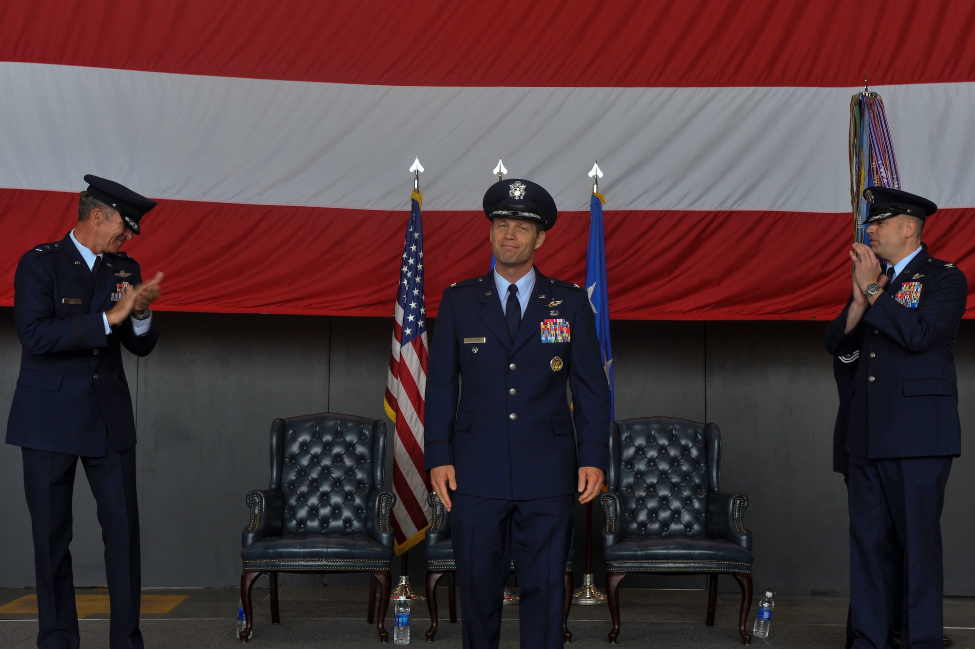 Col. James Dryjanski, 314th Airlift Wing commander, is congratulated by Maj. Gen. Michael Keltz, the director of Intelligence, Operations and Nuclear Integration, Headquarters Air Education and Training Command, and Col. Scott Brewer, former 314th AW commander, after assuming command July 31, 2014, at Little Rock Air Force Base, Ark. Dryjanski joins Team Little Rock with his wife, Celeste, and six children: Katherin, Alexis, Zoey, Thomas, Joshua and Adam. (U.S. Air Force photo by Senior Airman Regina Agoha)