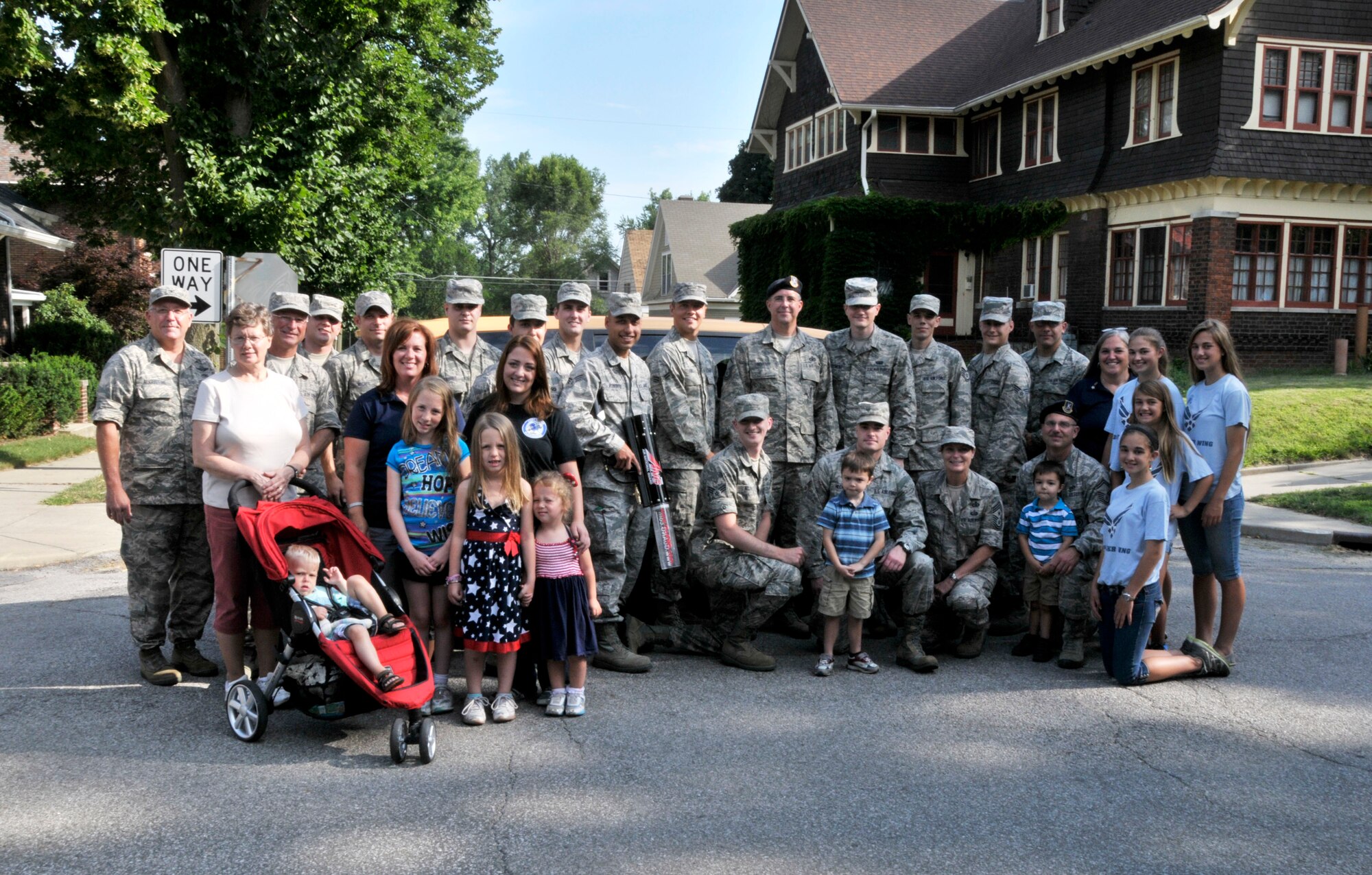 Members and volunteers from the 122nd Fighter Wing, Fort Wayne, Indiana pose for a group photo during the 46th Annual Three Rivers Festival Parade, July 12, 2014, held on the streets of downtown Fort Wayne. The yearly parade, attended by approximately 50,000 people, allows the wing to show its community support. (Air National Guard photo by Airman 1st Class Justin Andras/Released)