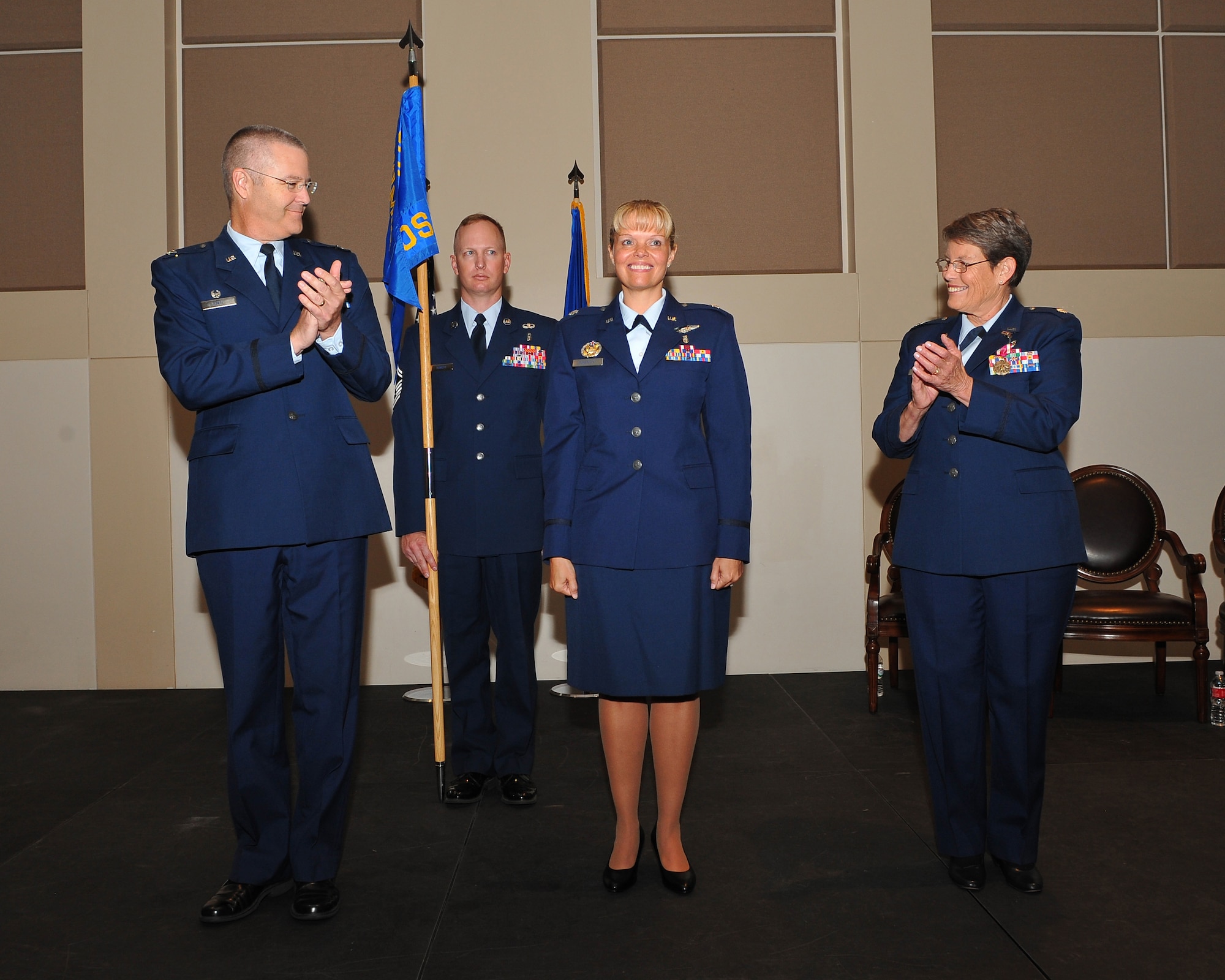 Col. Michael Kindt, 460th Medical Group commander, left, hands the 460th Medical Operations Squadron guidon to Lt. Col. Kelly Dorenkott, 460th MDOS commander, symbolizing her assumption of command during a change of command ceremony July 31, 2014, at the Leadership Development Center on Buckley Air Force Base, Colo. This will be Dorenkott’s second tour at Buckley, returning after serving as deputy chief of medical recruitment for the Office of the Air Force Surgeon General in Washington. (U.S. Air Force photo by Senior Airman Phillip Houk/Released)